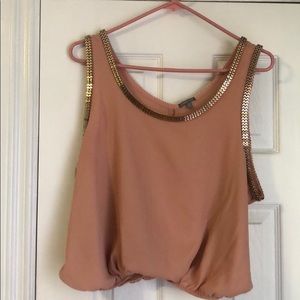 Blush top with gold metal accents